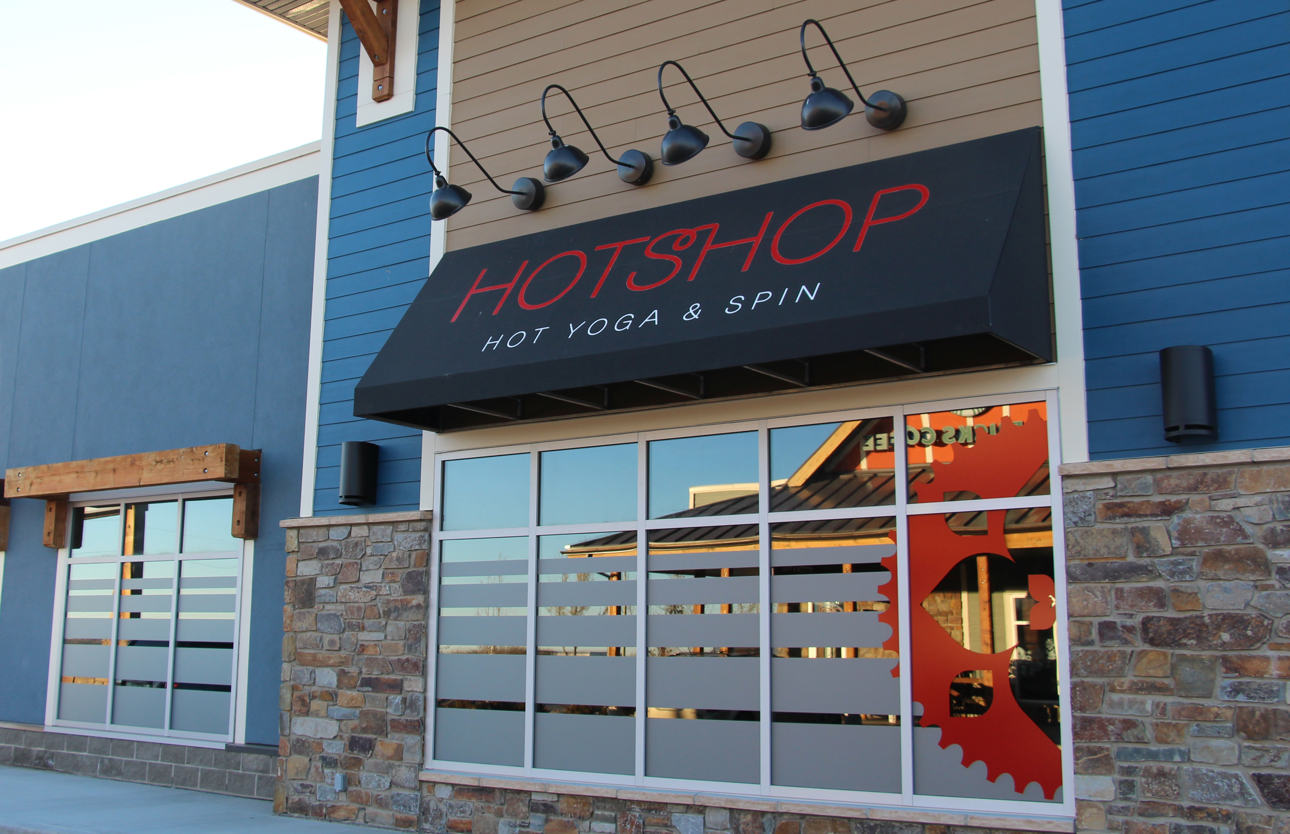 Frosted window etching alongside a red vinyl logo enhances this client's storefront.